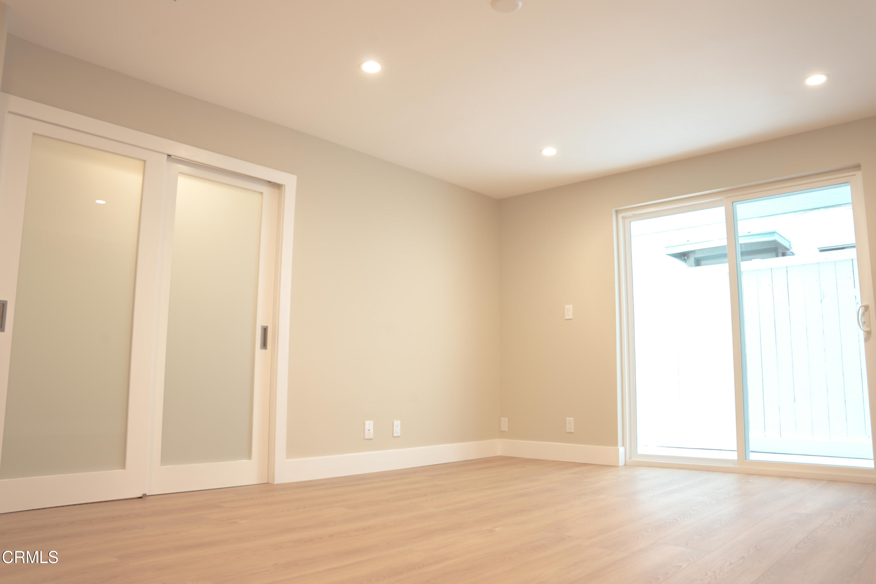 2517 Panama Drive Oxnard, CA 93035 - Photo 14 of 27 an empty room with wooden floor and windows