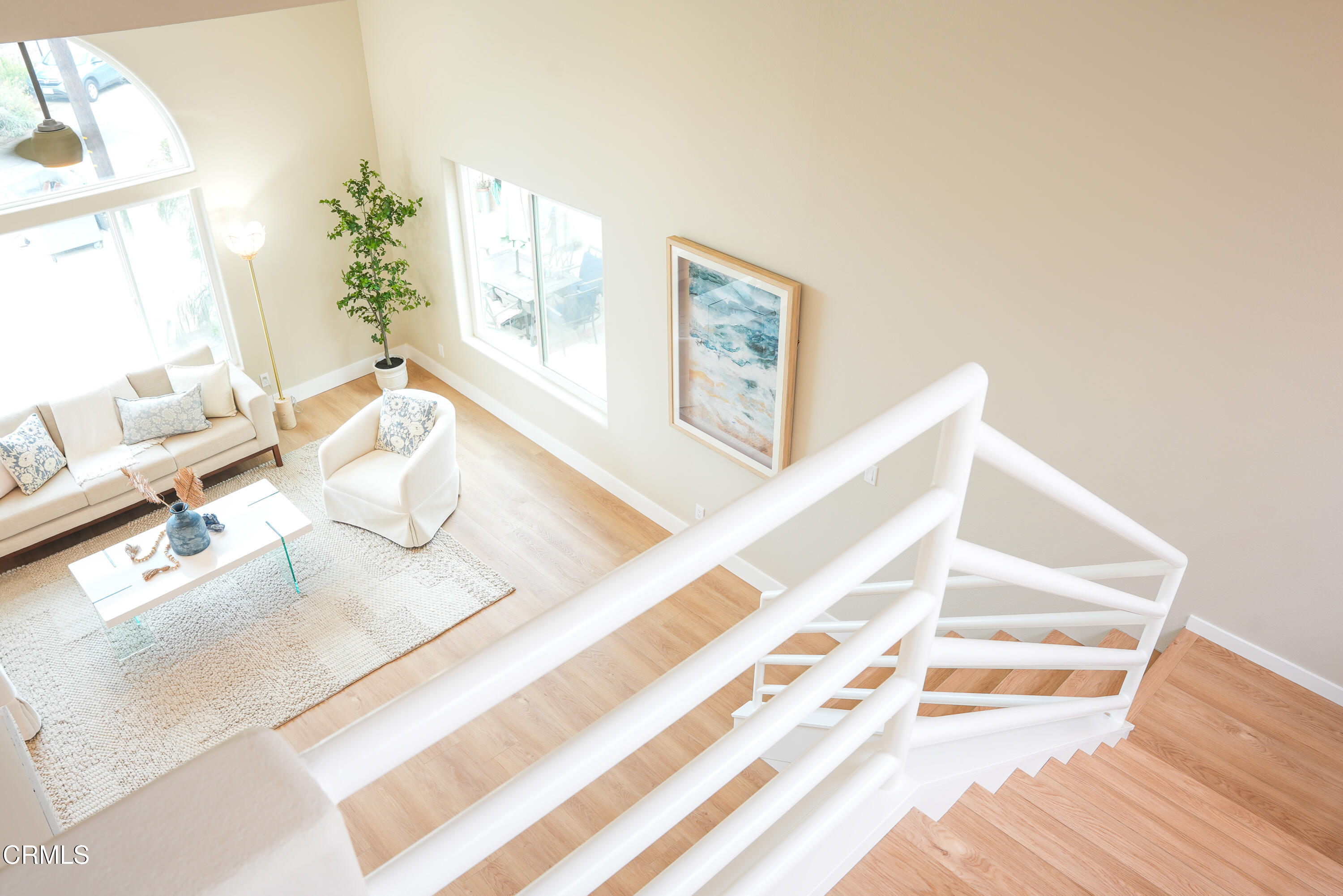 2517 Panama Drive Oxnard, CA 93035 - Photo 21 of 27 a living room with a bed and a potted plant on a wooden floor