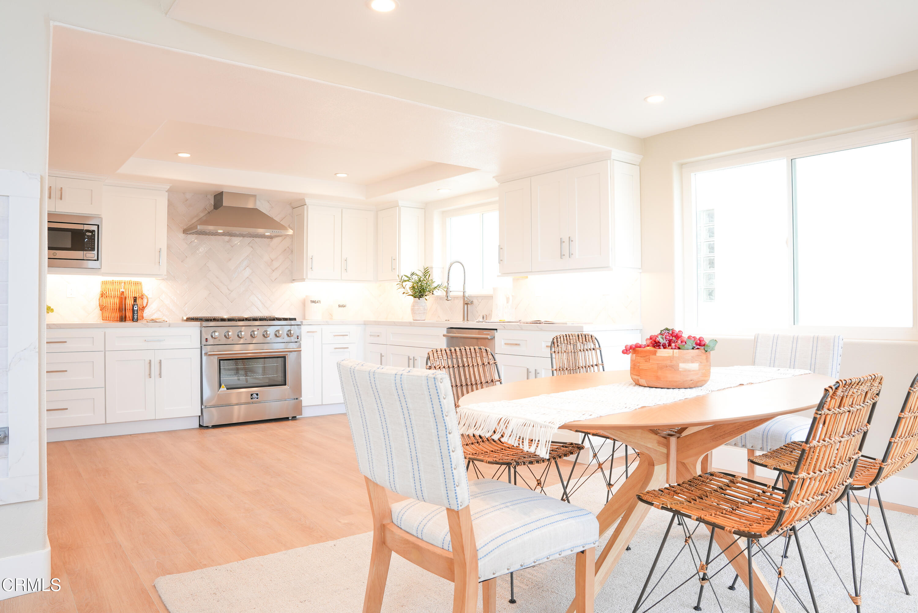 2517 Panama Drive Oxnard, CA 93035 - Photo 3 of 27 a kitchen with stainless steel appliances kitchen island granite countertop a table and chairs in it