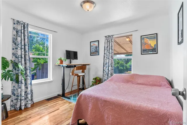 a bedroom with a bed and wooden floor