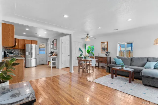 a living room with furniture and a wooden floor