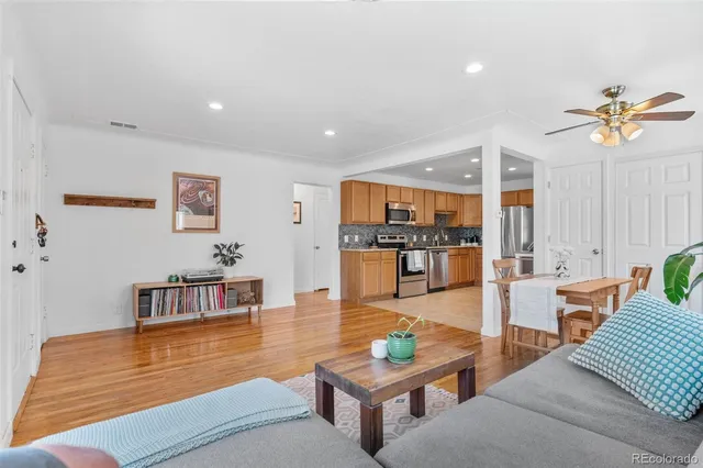 a living room with furniture and kitchen view