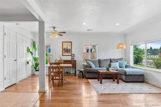 a living room with furniture and wooden floor