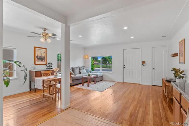 a living room with furniture and wooden floor