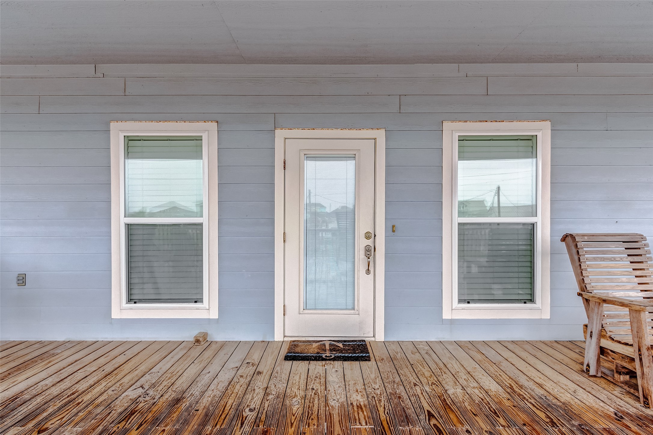 3093 Greg Street Crystal Beach, TX 77650 - Photo 12 of 48 a view of a room that has a dresser and chair with wooden floor