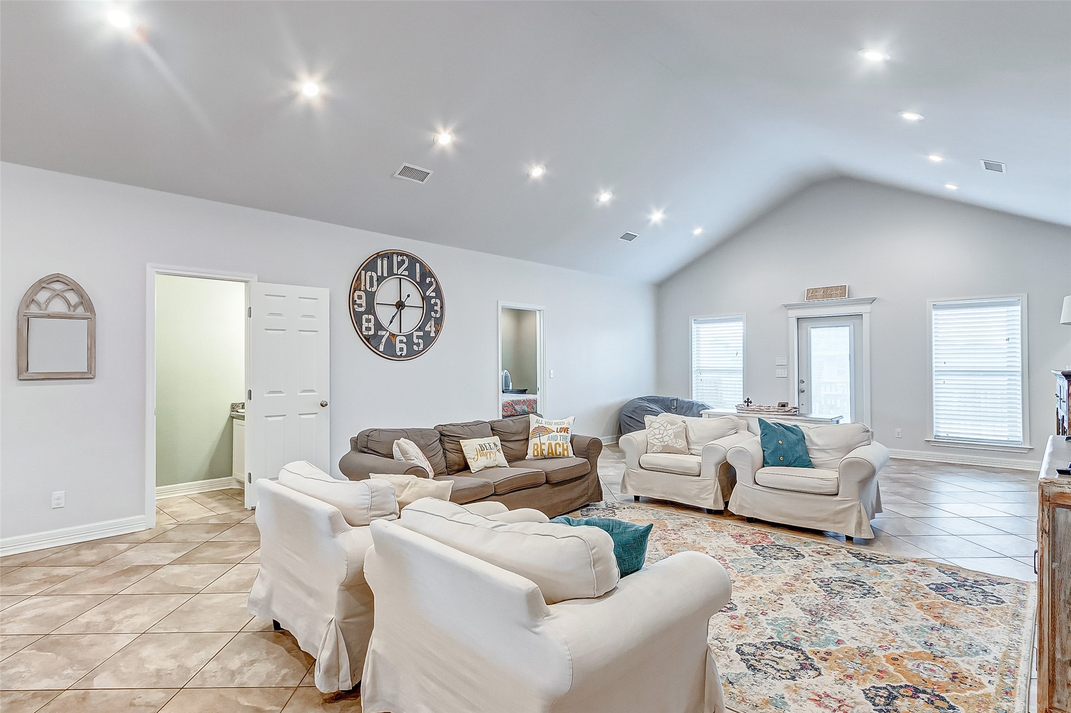 3093 Greg Street Crystal Beach, TX 77650 - Photo 19 of 48 a living room with furniture a clock on wall and a window