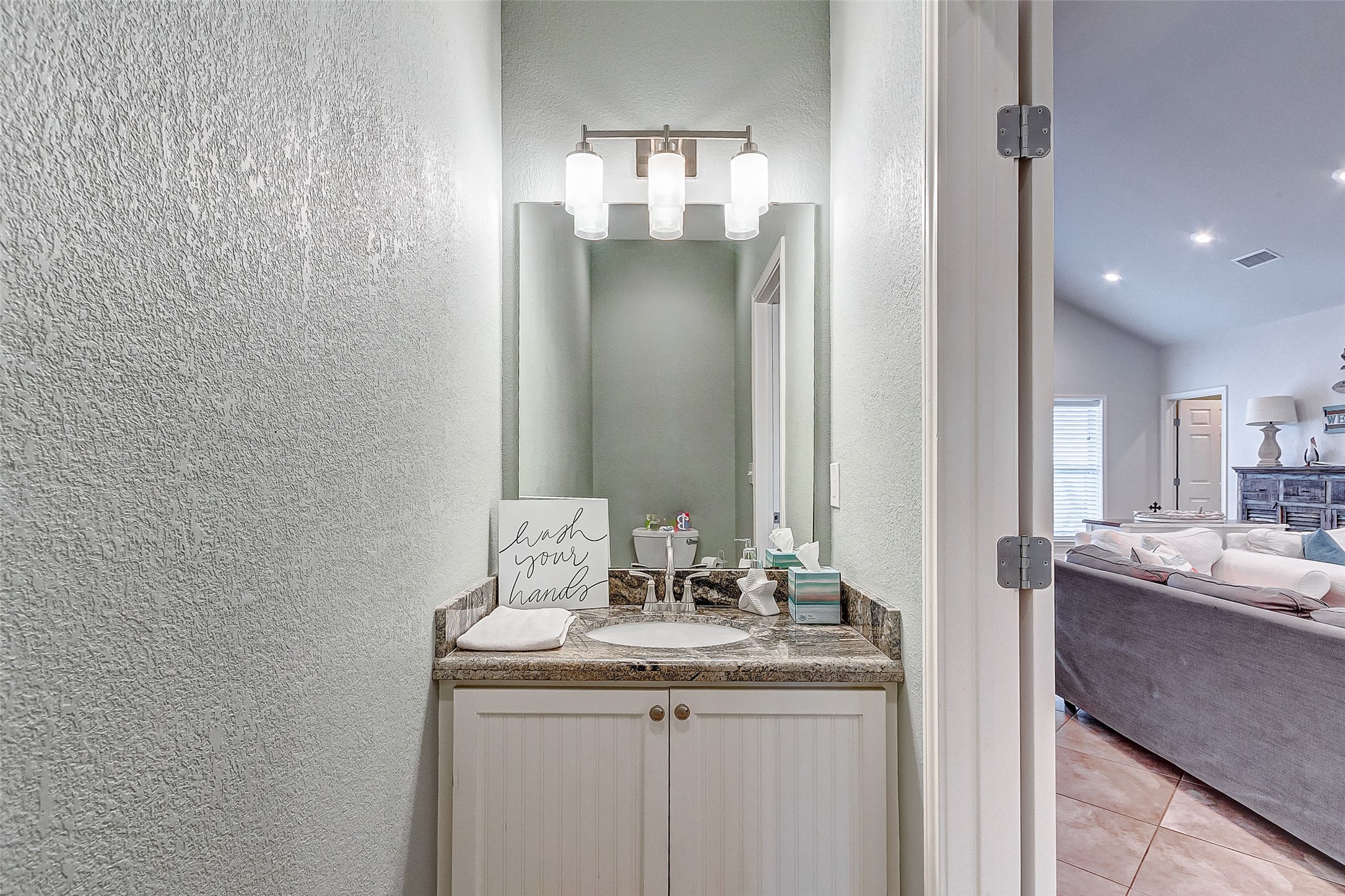 3093 Greg Street Crystal Beach, TX 77650 - Photo 24 of 48 a bathroom with a sink and a mirror
