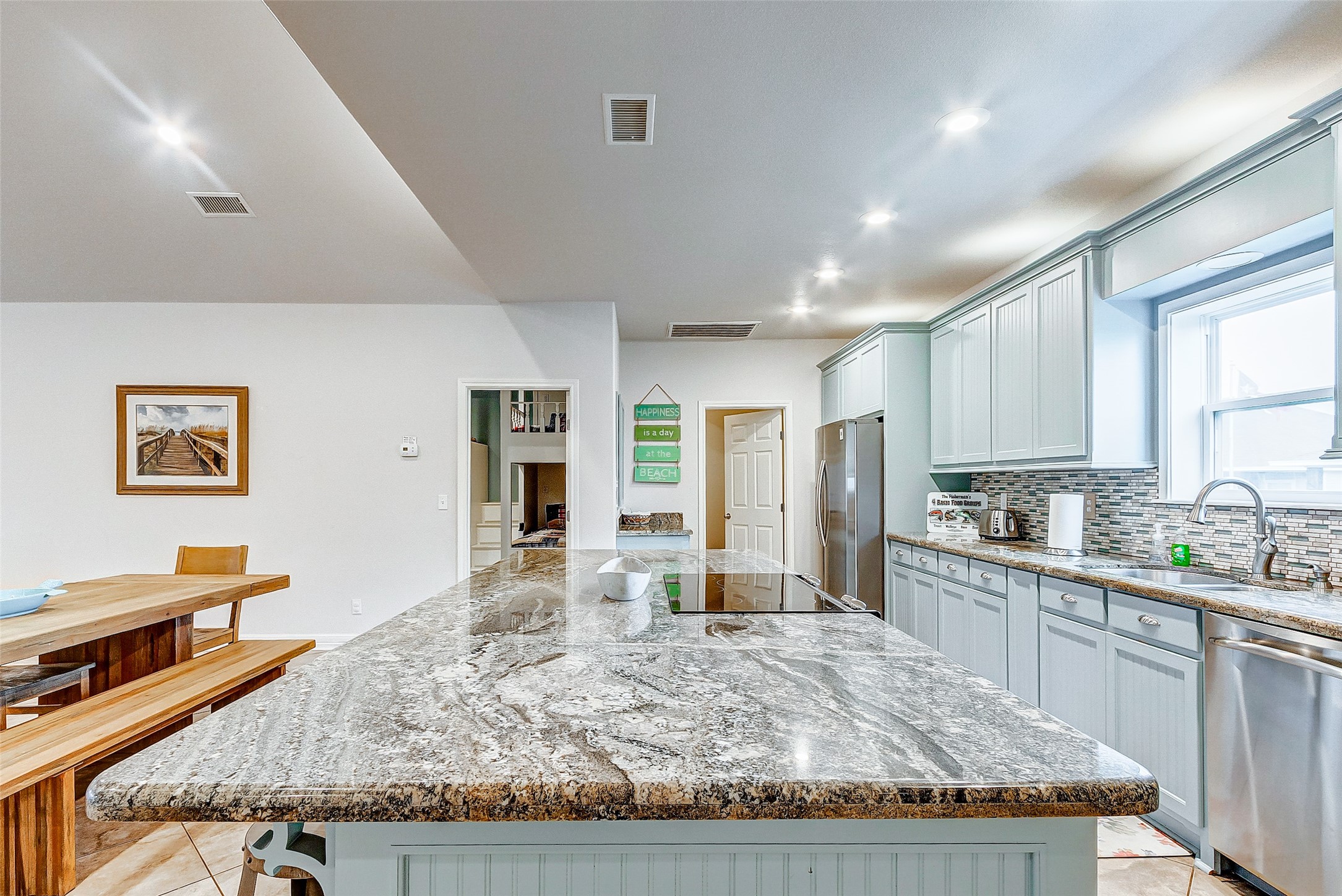 3093 Greg Street Crystal Beach, TX 77650 - Photo 26 of 48 a large kitchen with granite countertop lots of counter top space and stainless steel appliances