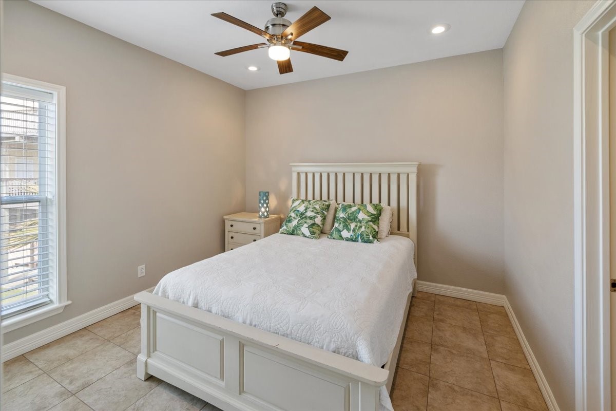 3093 Greg Street Crystal Beach, TX 77650 - Photo 29 of 48 a bed sitting in a room next to a window