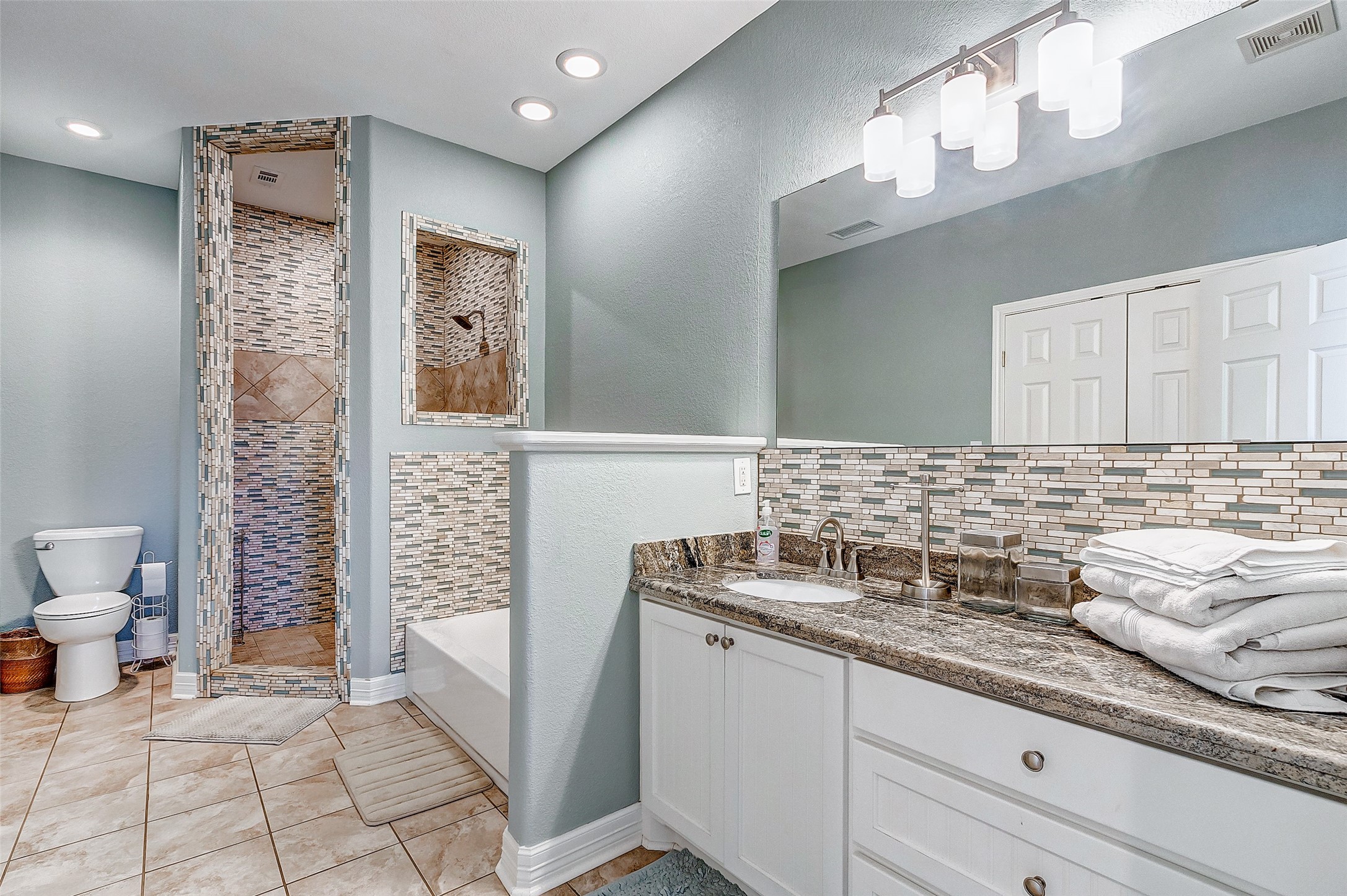 3093 Greg Street Crystal Beach, TX 77650 - Photo 32 of 48 a bathroom with a sink a toilet and a mirror