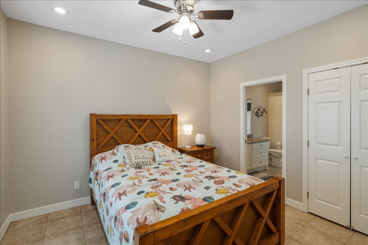 3093 Greg Street Crystal Beach, TX 77650 - Photo 36 of 48 a bedroom with a bed and a chandelier