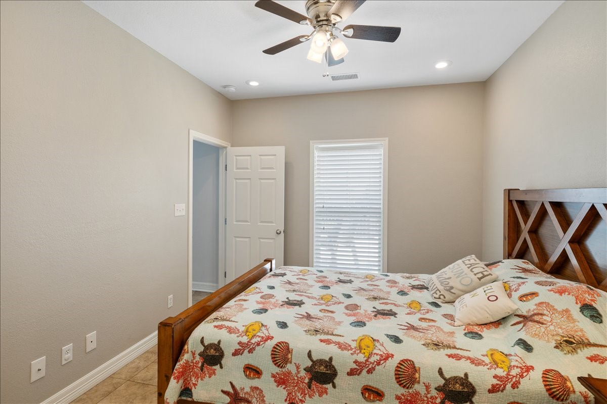 3093 Greg Street Crystal Beach, TX 77650 - Photo 37 of 48 a bedroom with a bed and a window