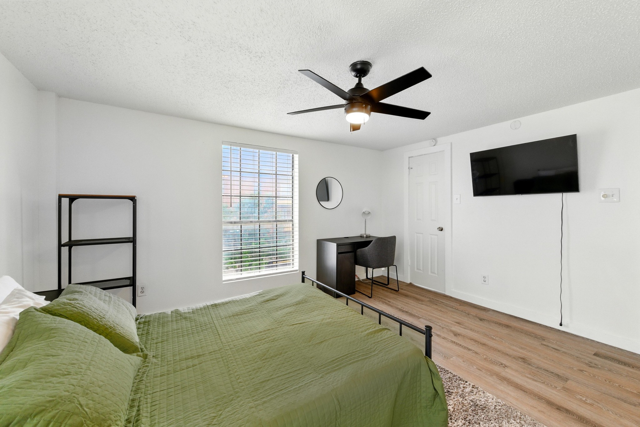 2401 Leon Street, Unit 306 Austin, TX 78705 - Photo 15 of 27 a bed room with a bed a television and a window