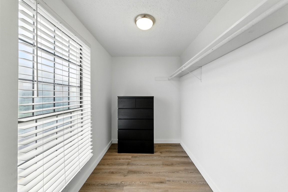 2401 Leon Street, Unit 306 Austin, TX 78705 - Photo 16 of 27 a view of a hallway with wooden floor and entryway