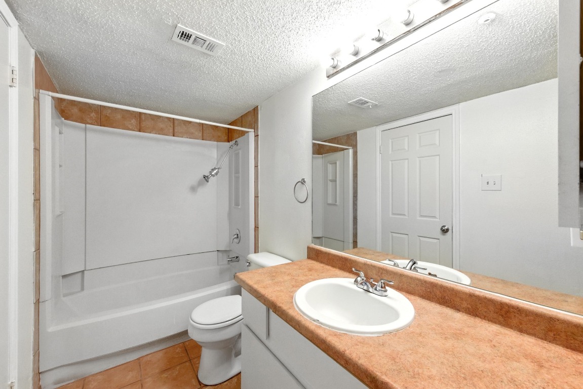 2401 Leon Street, Unit 306 Austin, TX 78705 - Photo 17 of 27 a bathroom with a sink a toilet and shower