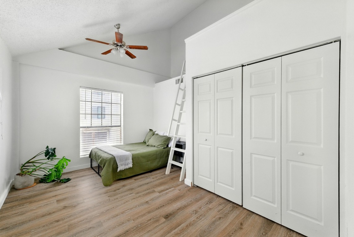 2401 Leon Street, Unit 306 Austin, TX 78705 - Photo 18 of 27 a living room with a bed furniture and a window