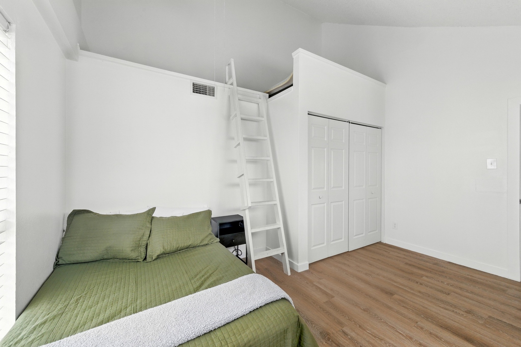 2401 Leon Street, Unit 306 Austin, TX 78705 - Photo 19 of 27 a living room with a couch and a wooden floor