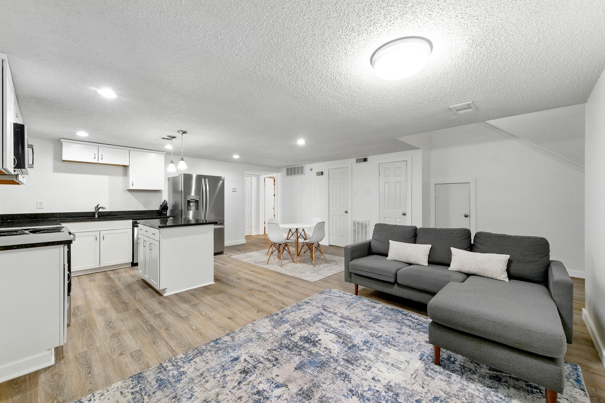 2401 Leon Street, Unit 306 Austin, TX 78705 - Photo 2 of 27 a living room with furniture and kitchen view
