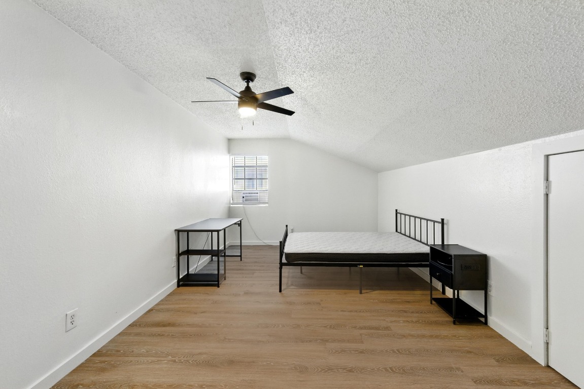 2401 Leon Street, Unit 306 Austin, TX 78705 - Photo 21 of 27 a view of a room with chairs and wooden floor