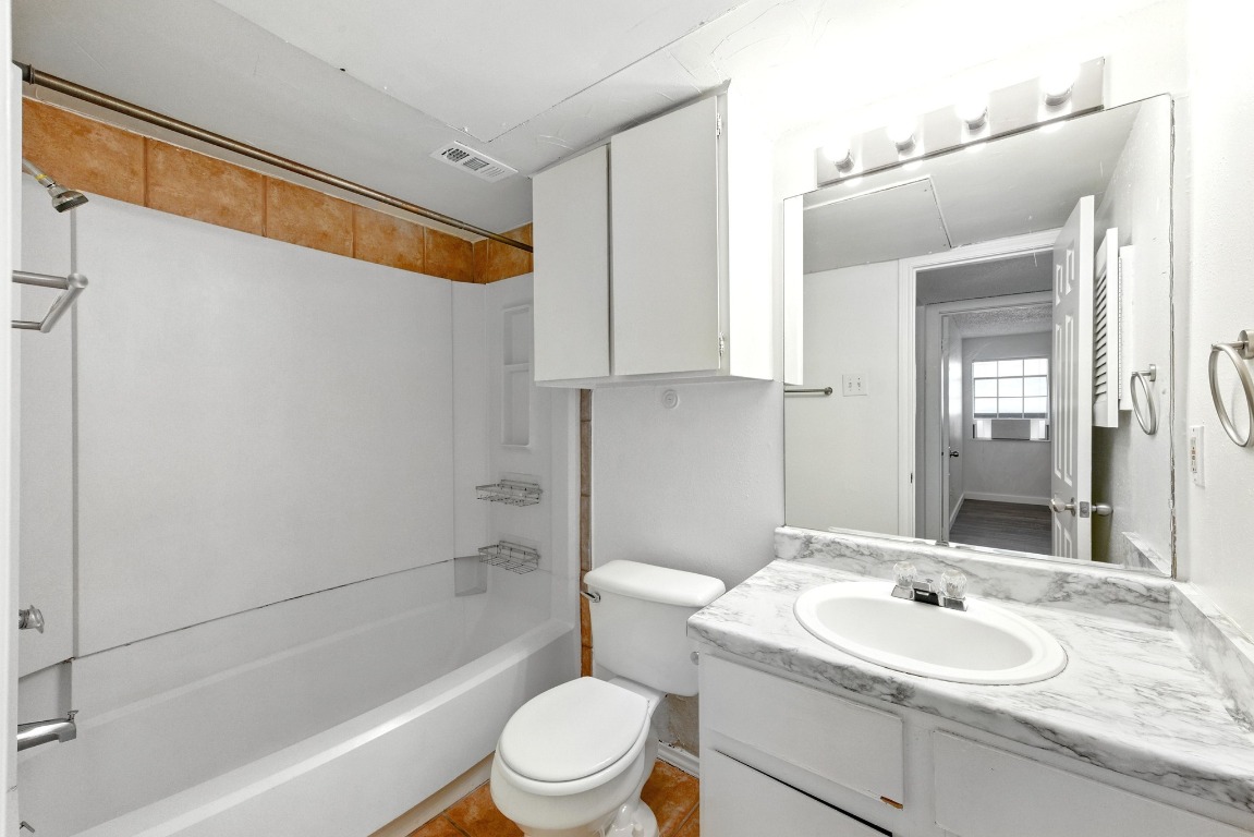 2401 Leon Street, Unit 306 Austin, TX 78705 - Photo 23 of 27 a bathroom with a sink toilet and shower