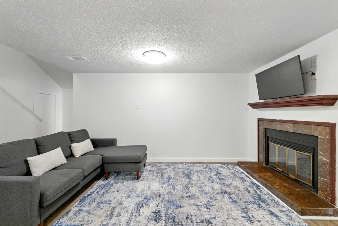 2401 Leon Street, Unit 306 Austin, TX 78705 - Photo 5 of 27 a living room with furniture and a fireplace