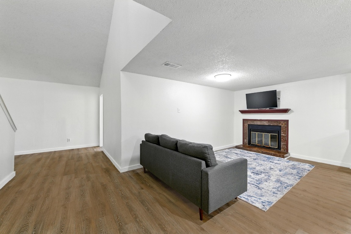 2401 Leon Street, Unit 306 Austin, TX 78705 - Photo 6 of 27 a living room with furniture and a fireplace