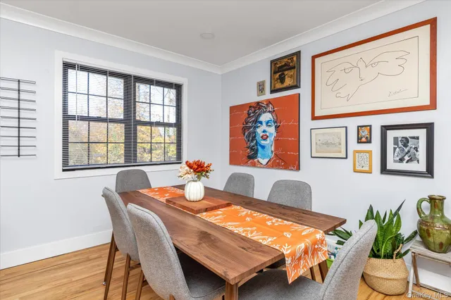 a living room with furniture and a dining table