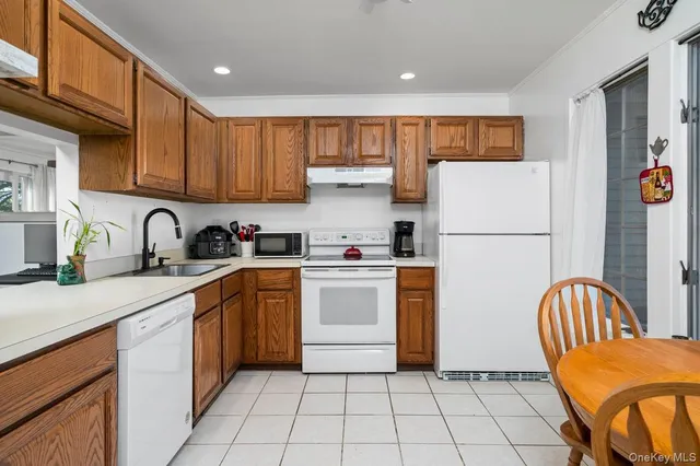 a kitchen with a refrigerator and a sink