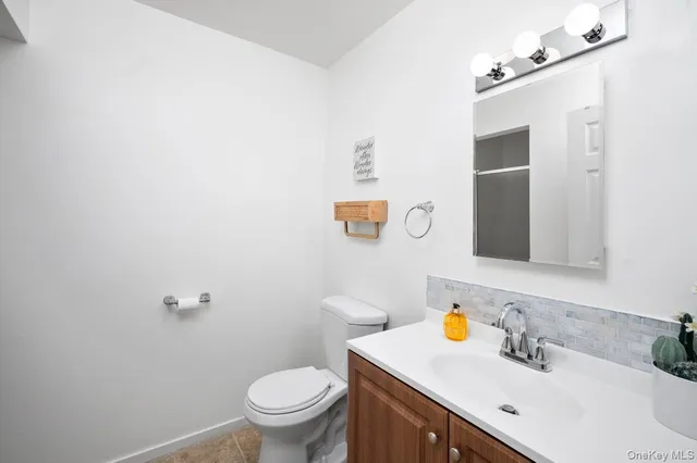 a bathroom with a sink toilet and a mirror