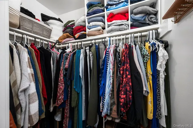a view of walk in closet with clothes