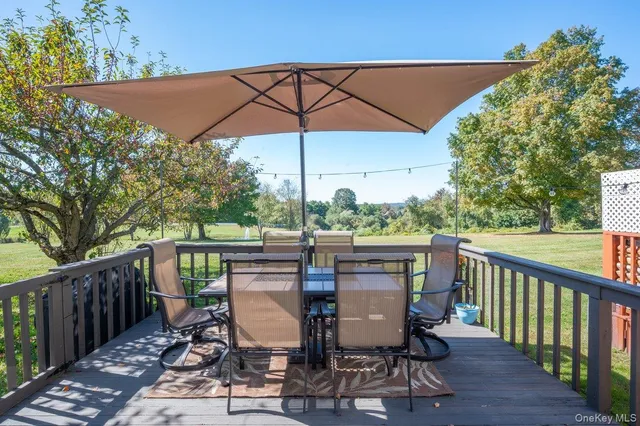 a view of a patio on wooden deck and a yard