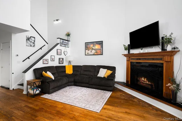 a living room with furniture a flat screen tv and a fireplace