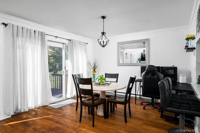 a view of a dining room with furniture and window
