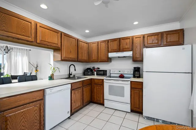 a kitchen with a sink a refrigerator and cabinets