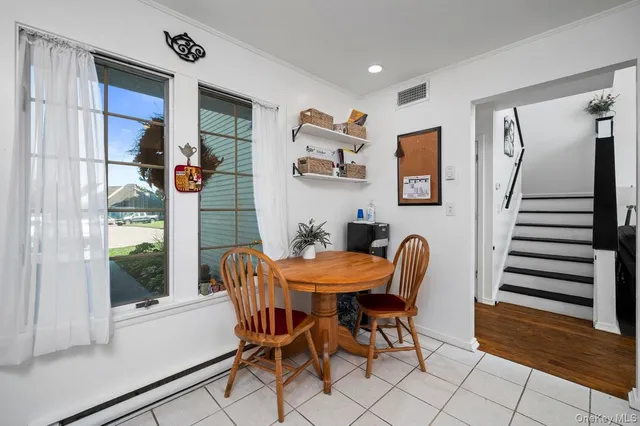 a dining room with furniture and wooden floor