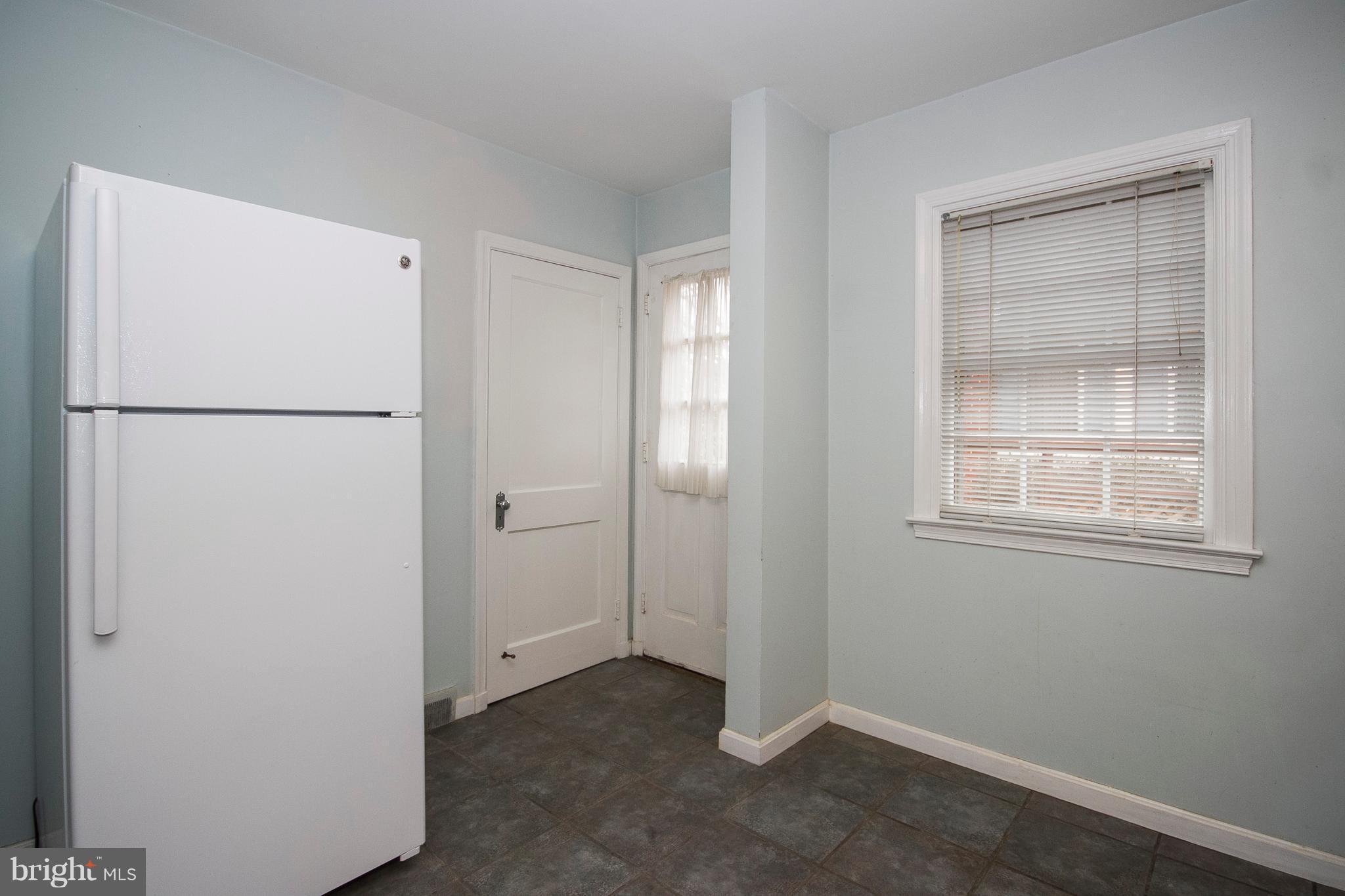 918 Litchfield Road Baltimore, MD 21239 - Photo 11 of 24 Kitchen with table space and door to exterior