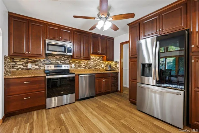 a kitchen with stainless steel appliances granite countertop a stove and a refrigerator