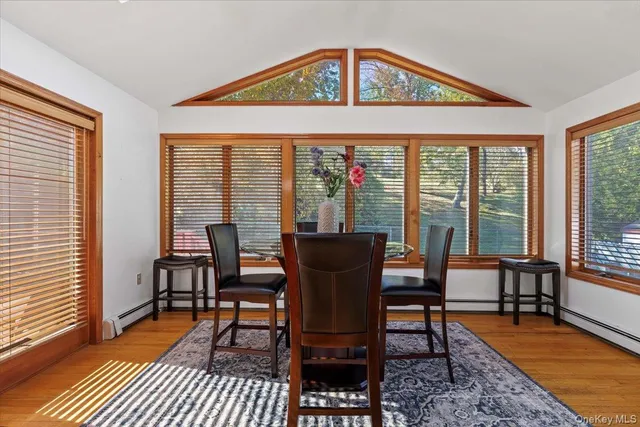 a view of a dining room with furniture window and wooden floor
