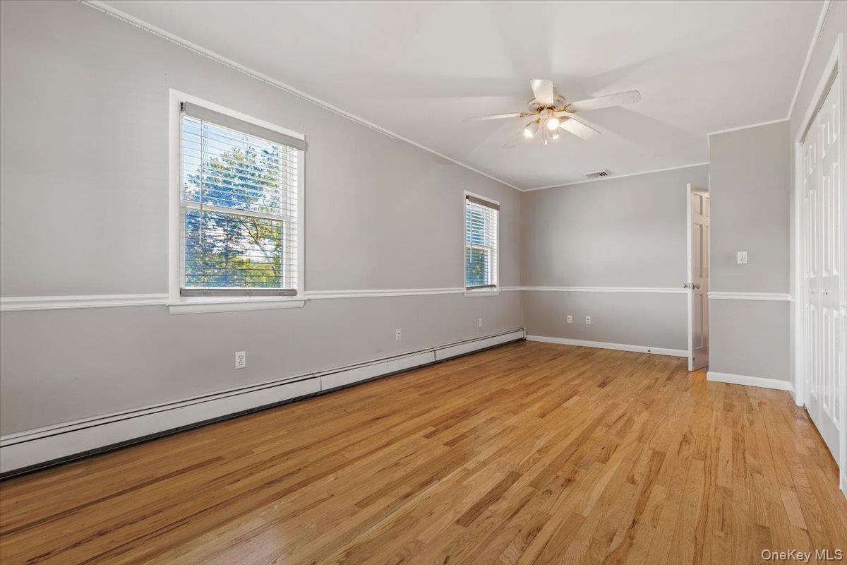56 Daley Road Poughkeepsie, NY 12603 - Photo 17 of 35 an empty room with wooden floor fan and windows