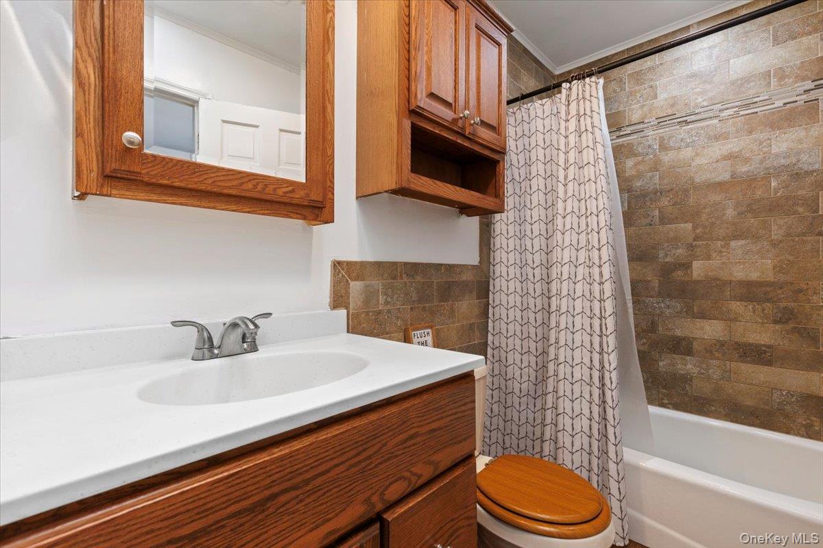 56 Daley Road Poughkeepsie, NY 12603 - Photo 22 of 35 a bathroom with a sink a toilet and shower