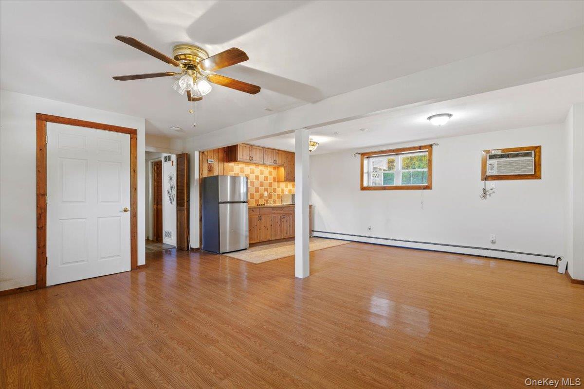 56 Daley Road Poughkeepsie, NY 12603 - Photo 23 of 35 a view of an empty room with wooden floor and a ceiling fan