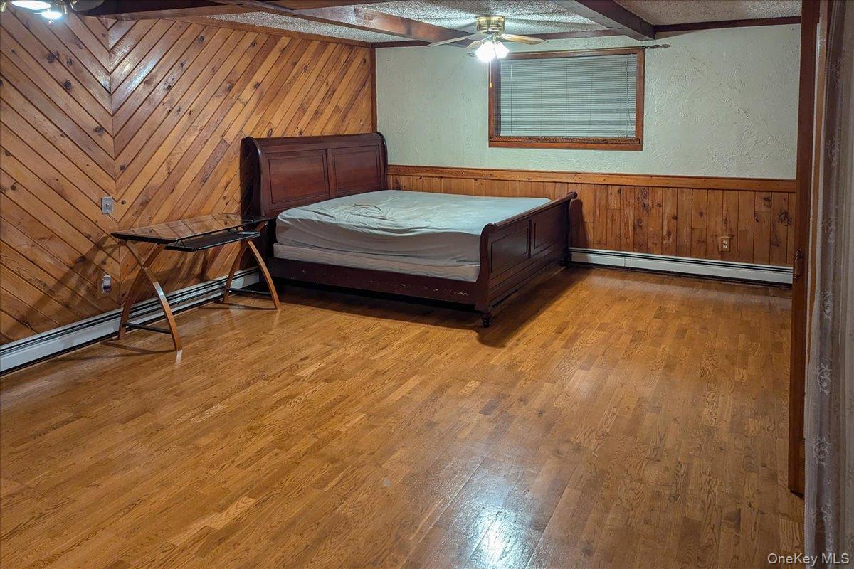 56 Daley Road Poughkeepsie, NY 12603 - Photo 26 of 35 a bedroom with a bed and wooden floor