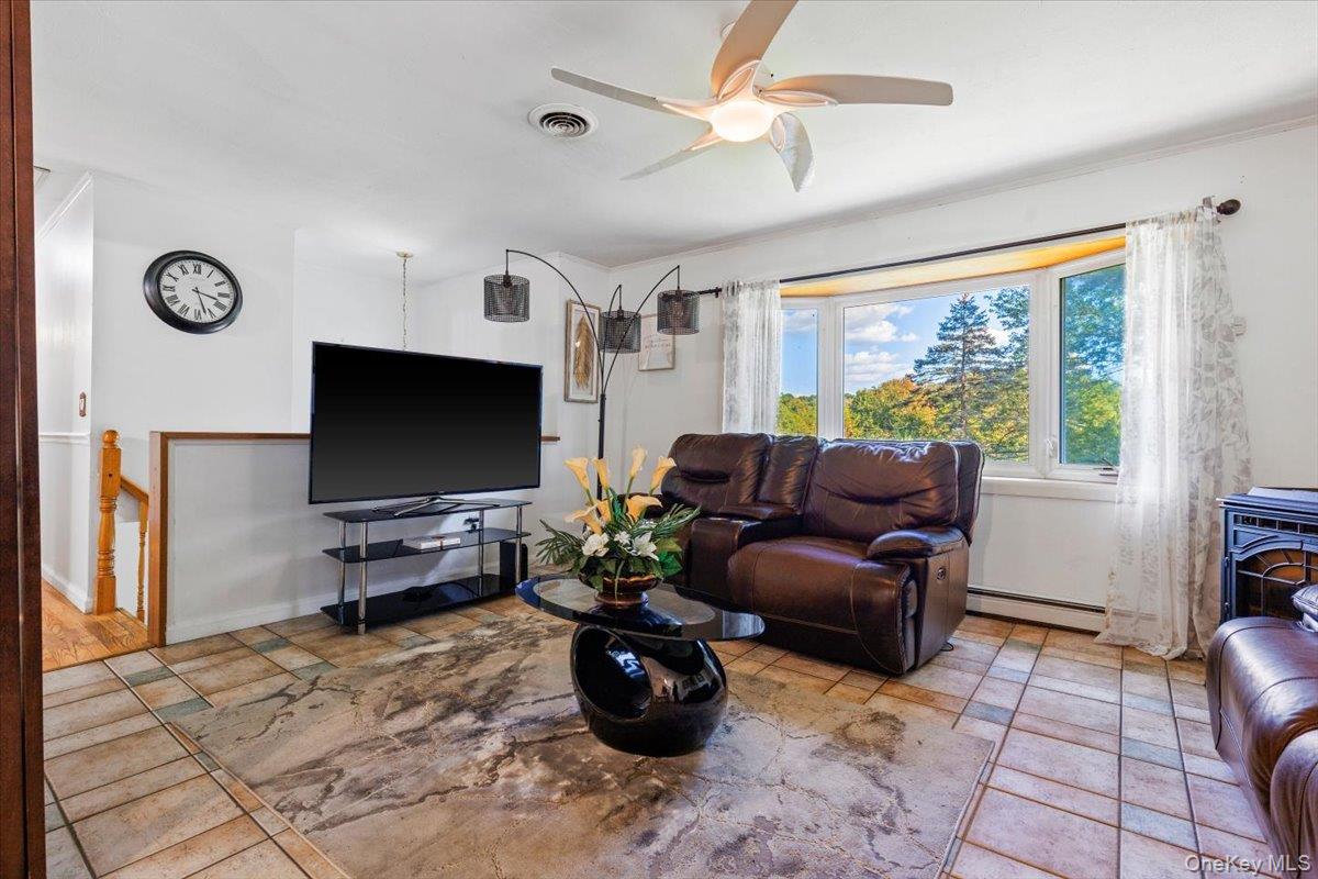 56 Daley Road Poughkeepsie, NY 12603 - Photo 5 of 35 a living room with furniture and a flat screen tv
