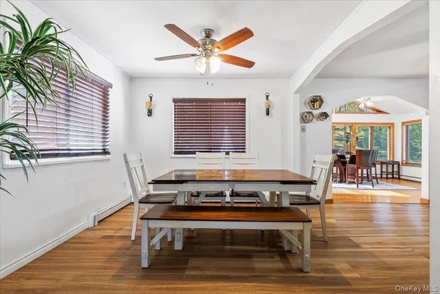 a living room with furniture a table and a large window