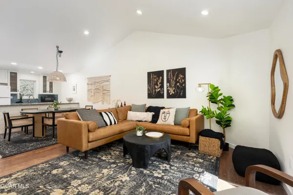 a living room with furniture potted plant and a window