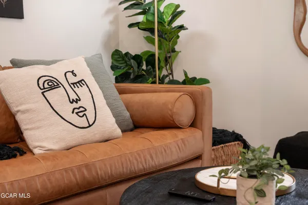 a living room with furniture and a potted plant