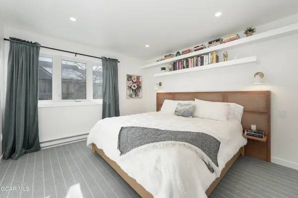 a large white bed in a white room