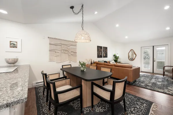 a view of a dining room with furniture and wooden floor