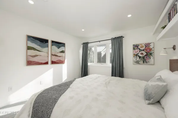 a bedroom with a bed and a mirror