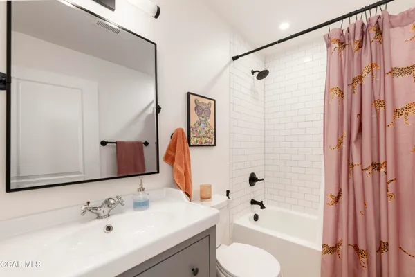 a bedroom with a bed and a mirror